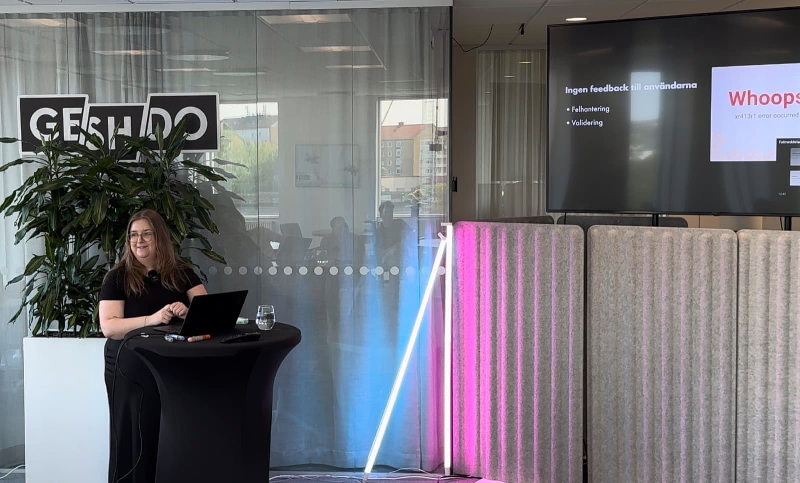 Amanda holding a UX presentation in front of an audience